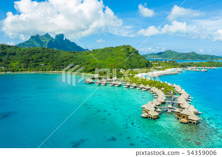 Travel vacation paradise aerial image with overwater bungalows in coral reef sea 54359006
