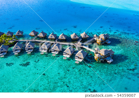 Travel vacation paradise aerial image with overwater bungalows in coral reef sea 54359007