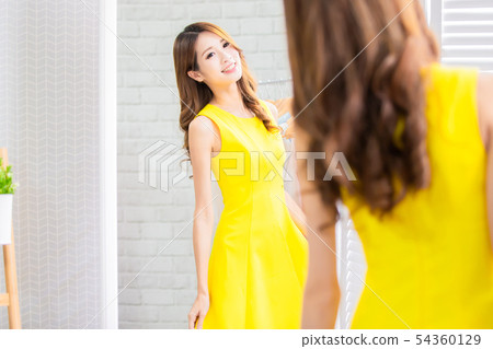asian girl trying dress happily asian girl trying dress happily 54360129