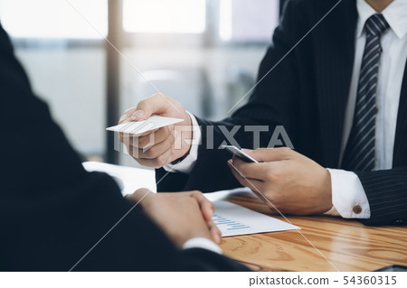 Businessman giving a business card. Businessman giving a business card. 54360315