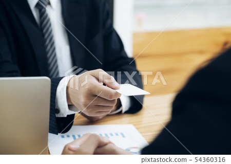 Businessman giving a business card. Businessman giving a business card. 54360316
