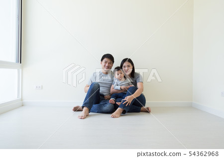 Happy Asian family with empty room in new house Happy Asian family with empty room in new house 54362968