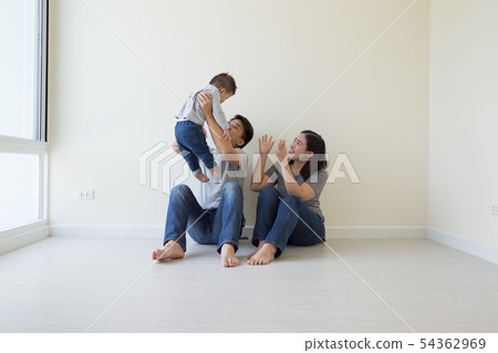 Happy Asian family with empty room in new house Happy Asian family with empty room in new house 54362969