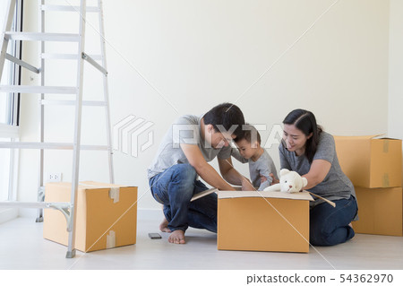 Happy Asian family with cardboard boxes new home Happy Asian family with cardboard boxes new home 54362970