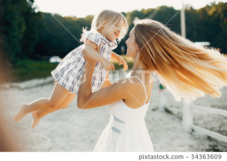 Mother with daughter playing in a summer park Mother with daughter playing in a summer park 54363609