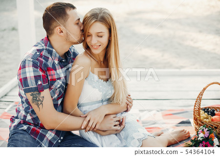 Beautiful couple spend time in a summer park 54364104