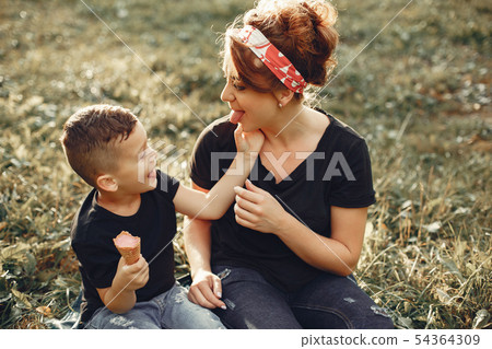 Mother with son playing in a summer park 54364309