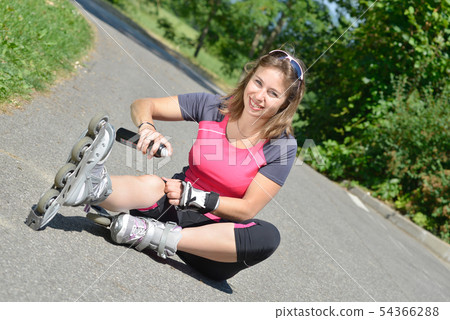young woman fell on skates young woman fell on skates 54366288