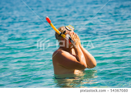 Man with snorkeling tube in sea 54367080