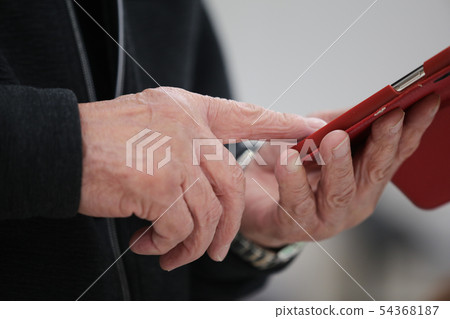 Senior generation operating a mobile phone Senior generation operating a mobile phone 54368187