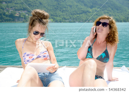 two young women natural at the waterfront two young women natural at the waterfront 54368342
