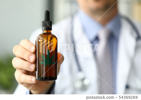 Male doctor hold bottle with marijuana oil Male doctor hold bottle with marijuana oil 54369269