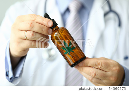 Male doctor hold bottle with marijuana oil Male doctor hold bottle with marijuana oil 54369273