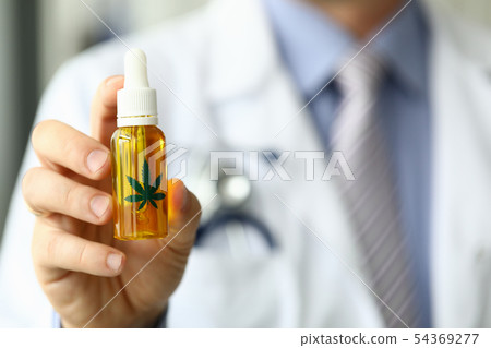 Male doctor hold bottle with marijuana oil Male doctor hold bottle with marijuana oil 54369277