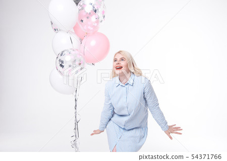 Portrait of dress of a cheerful beautiful girl is standing near a bunch of colorful balloons and Portrait of dress of a cheerful beautiful girl is standing near a bunch of colorful balloons and 54371766