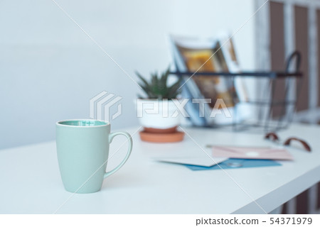 White desk table with copy space, supplies and coffee mug. Front view workspace and copy space. White desk table with copy space, supplies and coffee mug. Front view workspace and copy space. 54371979