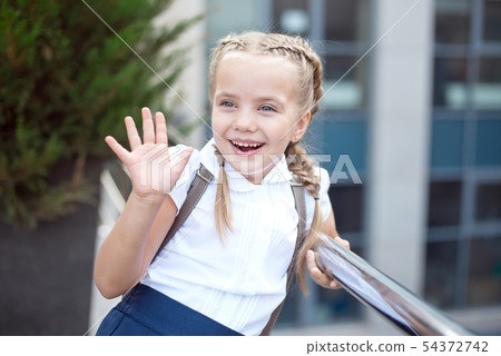 Happy smiling girl is going to school for the first time with bag go to elementary school 54372742