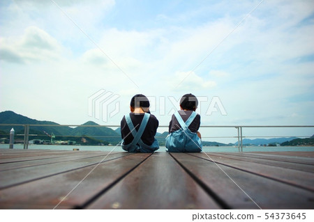 A boy watching the sea 54373645