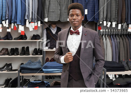 Male client of shop wearing in grey suit, looking at camera. 54373985