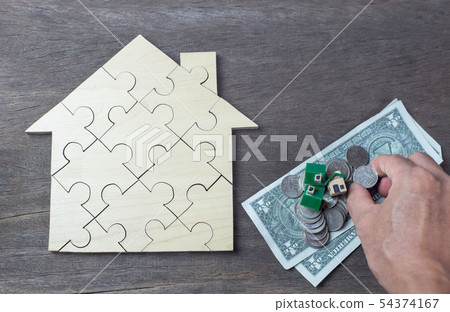 house and coins stack in front of Savings money of 54374167