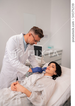 Client wearing white bathrobe having beauty injections 54375239