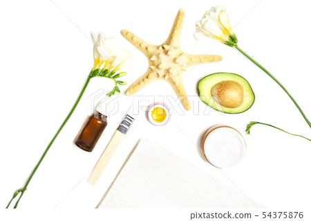 Beauty concept avocado, skin care facial essence oil, brush, lily flower and towel on white 54375876