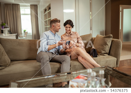 Husband supporting wife while waiting for plastic surgeon in beauty clinic Husband supporting wife while waiting for plastic surgeon in beauty clinic 54376375