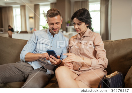Businessman searching information with wife about plastic surgery Businessman searching information with wife about plastic surgery 54376387