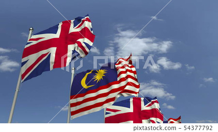 Flags of Malaysia and the United Kingdom against blue sky, 3D rendering Flags of Malaysia and the United Kingdom against blue sky, 3D rendering 54377792
