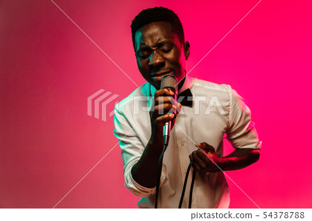 Young african-american jazz musician singing a song 54378788
