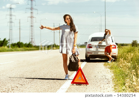 Young couple traveling on the car in sunny day 54380254