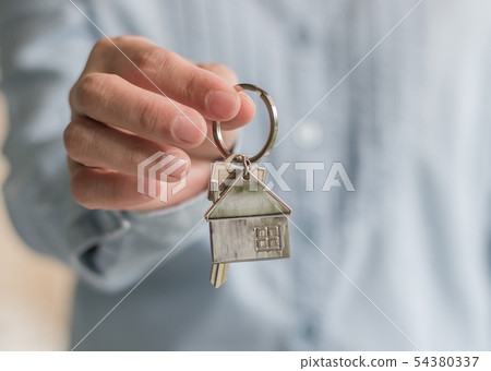 Home buyer or sale agent giving key for leasing 54380337