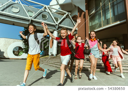 Happy kids playing at city's street in sunny summer's day Happy kids playing at city's street in sunny summer's day 54380650