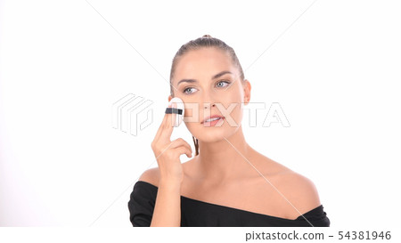 Beauty concept. Young woman applying blusher on 54381946