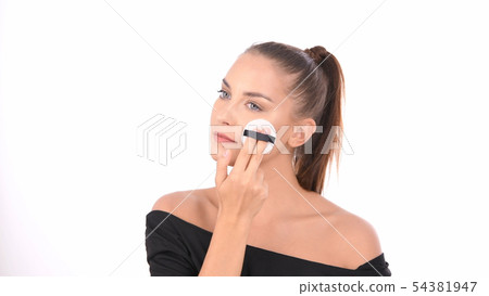 Beauty concept. Young woman applying blusher on 54381947