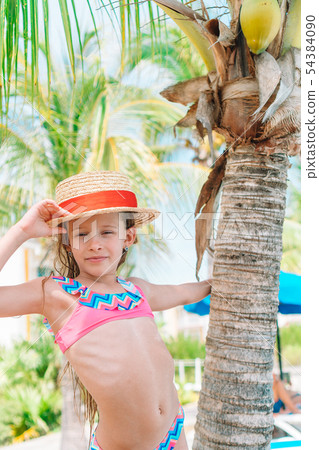 Beautiful little girl at beach having fun. Funny girl enjoy summer vacation. 54384090