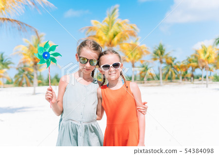 Adorable little girls during summer tropical vacation 54384098