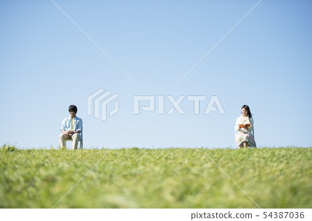 Men listening to music and women reading books 54387036