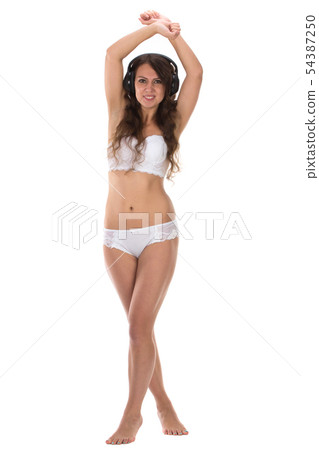 Attractive Sexy woman with beautiful body posing with headphones. Attractive Sexy woman with beautiful body posing with headphones. 54387250