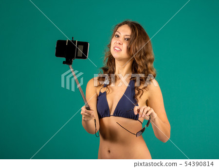 Woman in swimsuits taking a selfie. Woman in swimsuits taking a selfie. 54390814
