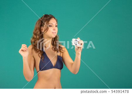 Travel concept. Woman with camera 54391478