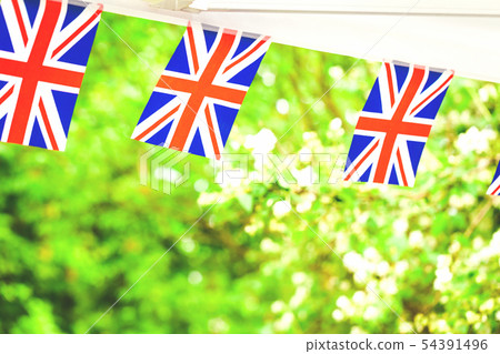 Union jack flags in summer garden party Union jack flags in summer garden party 54391496