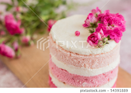 Beautiful pink cream and berries cake  54391889