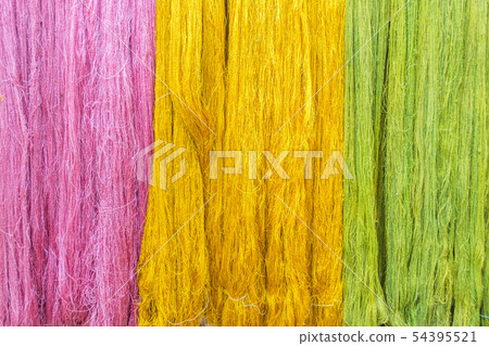 Thai silk threads fiber in pink, green and yellow Thai silk threads fiber in pink, green and yellow 54395521