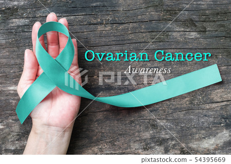Teal ribbon on helping hand support for raising 54395669