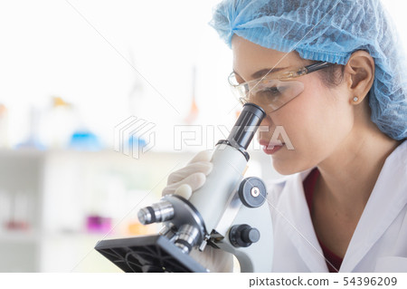 Scientist look throgh microscope.. Scientist look throgh microscope.. 54396209