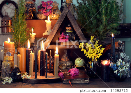 Burning candles, flowers and crystal gem Burning candles, flowers and crystal gem 54398715