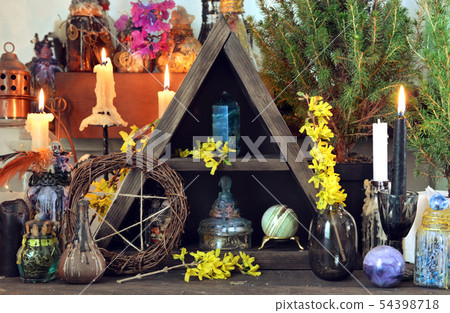 Witch altar with pentagram, spring flowers 54398718