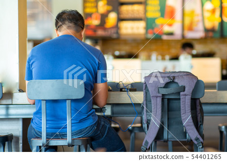 Back portrait Asian young man works at coffee shop Back portrait Asian young man works at coffee shop 54401265