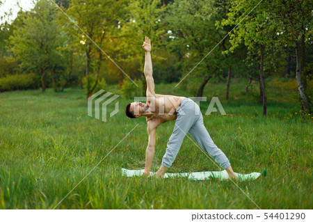 Young man practicing yoga outdoors Young man practicing yoga outdoors 54401290